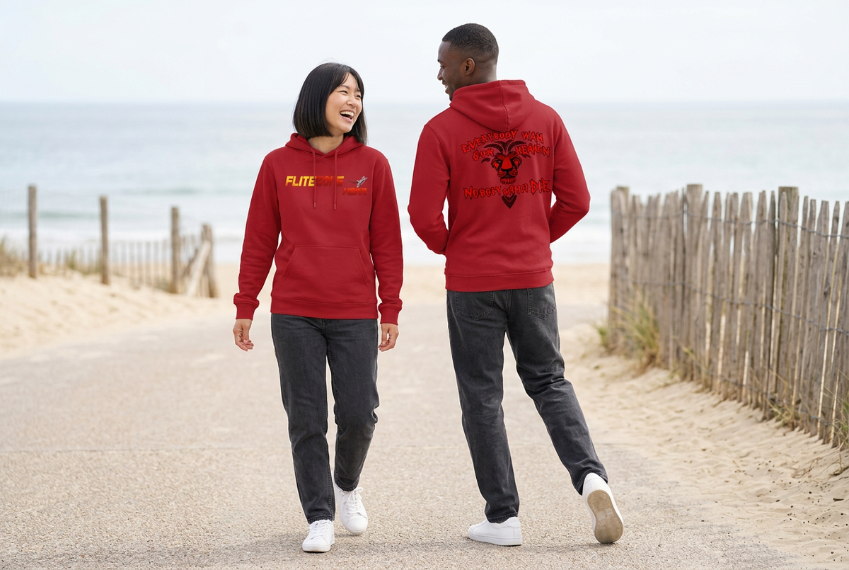 Playful seaside scene with an East Asian woman showing the red hoodie front and a Black man showing the back