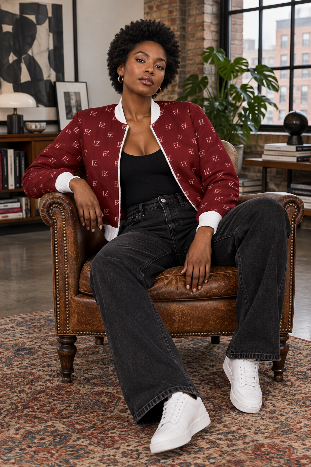 Black woman in the women's burgundy FZ bomber in a loft apartment