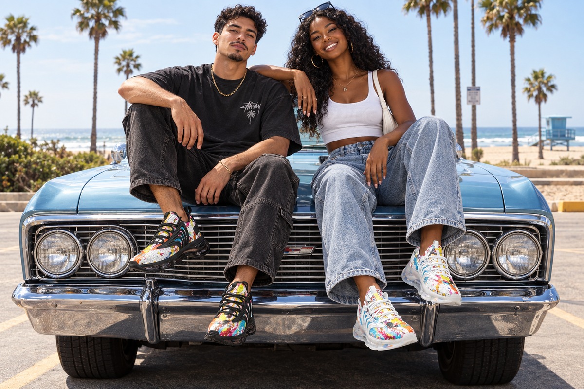 Latino man and Black woman on a vintage car at a beach lot in the paint-splatter sneakers