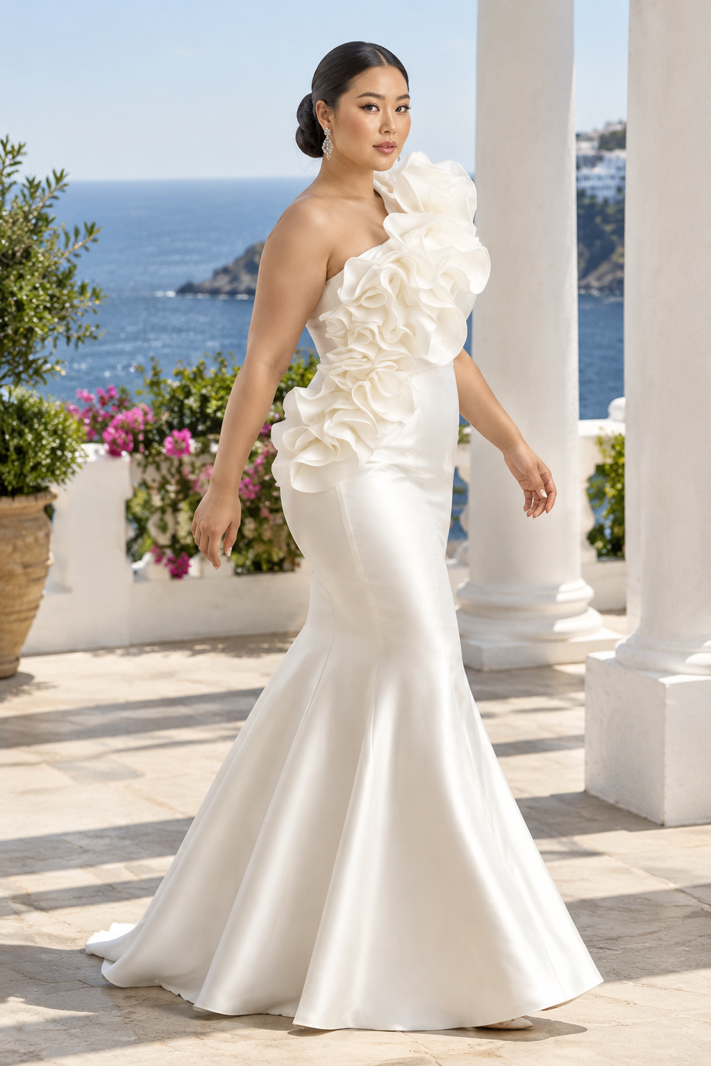 Plus-size East Asian model walking on a seaside terrace in the ivory ruffle gown