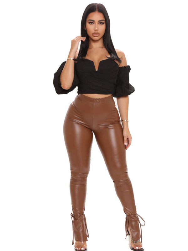 women’s vegan leather pants with adjustable suspender straps and slit